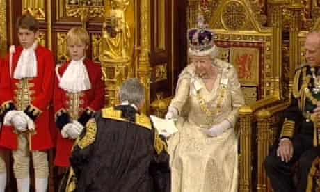 Queen Elizabeth II hands over papers after the Queen's Speech at the State Opening of Parliament.