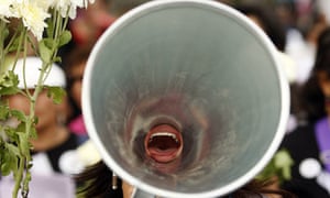 A woman shouts through a megaphone in Lima