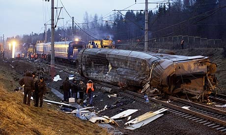 Russian investigators and rescue workers at the site of the train crash near Uglovka