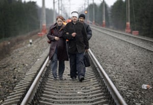 Russia Train Crash: Passengers walk along the track away from the site of a train derailment 