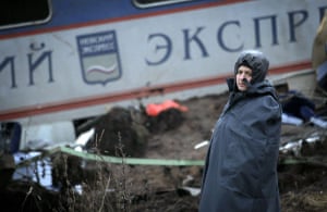 Russia Train Crash: A Russian police officer guards a damaged coach from a train derailment