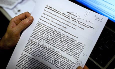 A journalist reads the latest draft of the Copenhagen Accord at the climate summit