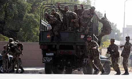 Pakistani soldiers secure the scene after an attack on a Rawalpindi mosque near army headquarters