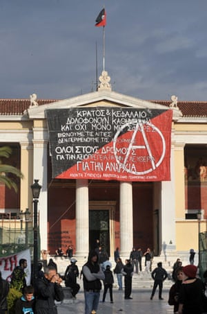 Athens demonstrations: A black and red flag is placed where a Greek flag on the Athens Academy