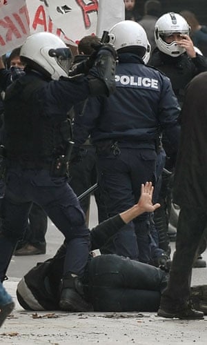 Violence in Athens: Police detains a demonstrator during a massive demonstration