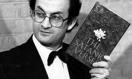 Salman Rushdie holding a copy of his book The Satanic Verses