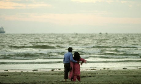 A Pakistani young couple walk on a beach on 2007's Valentine's Day in Karachi