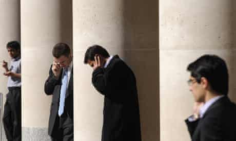 City workers make phone calls outside the London Stock Exchange
