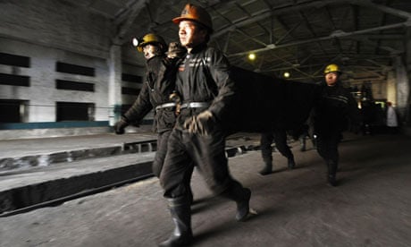 Rescue workers carry body of victim of blast in coal mine in north China's Shanxi Province