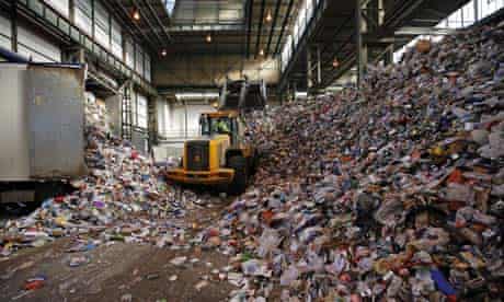 A digger moves waste at Greenstar Recycling facility at Aldridge near Walsall