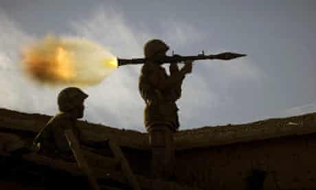 A Pakistani soldier fires toward militant positions