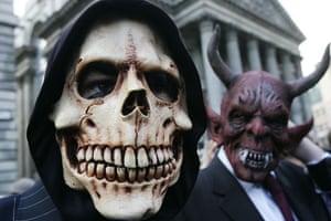 G20 protests and security: Protesters in masks and suits gather outside the Bank of England