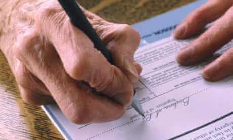 An elderly man signing a Will