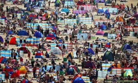 Holidaymakers on the beach in Newquay, Cornwall