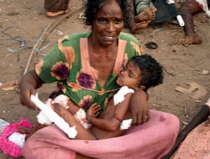 Tamil Tigers surrender: An injured Tamil woman cradling her child