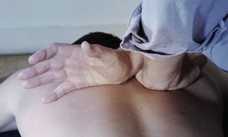 Chiropractor manipulates a man's spine