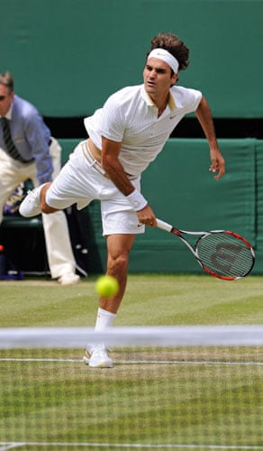 friday wimbledon: Federer smashes a serve over the net
