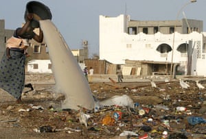 Garbage: A Senegalese woman discards waste water in Yoff outside Dakar, Senegal