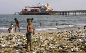 Garbage: A girl stands on garbage on the beach  in Haina in the Dominican Republic