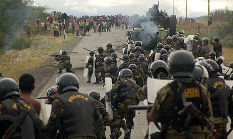 Police officers take up positions during clashes with protesters in Bagua province, Peru.