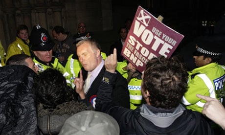 Demonstrators confront a British National Party member 