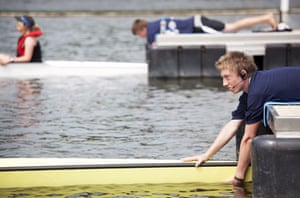 Henley Royal Regatta: A 'stake-boat boy 'keeps a boat steady for the start of a race