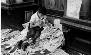 Boy reading newspaper, New York, 1944
