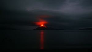 Krakatau volcano: Anak Krakatau's eruptions illuminate low cloud and reflect off the sea