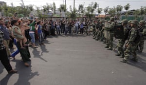 Uighurs protest: Protest by Uighurs against security forces at an official press tour 