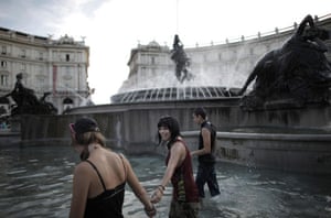 G8 preparations: Demonstrators walk in a fountain on Piazza della Repubblica to demonstrate