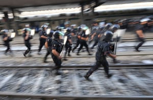 G8 preparations: Riot policemen run after protesters on the tracks of Termini station