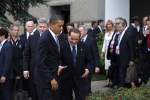 G8 summit: Silvio Berlusconi leans to shake hands with US President Barack Obama