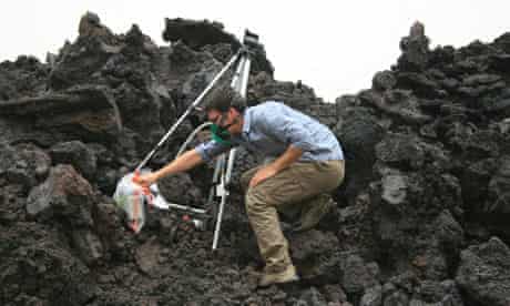 David Ferguson collects samples from a lava flow