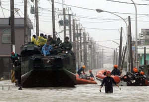 Typhoon Morakot: Chiatung, Taiwan: Evacuees sit on top of a military vehicle