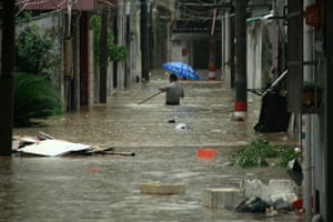 Typhoon Marakot: Leqing county, China: A man walks in a flooded street