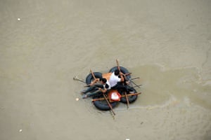 Typhoon Marakot: Cangnan county, China: Two men row a makeshift raft