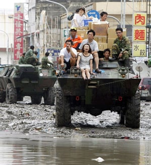 Typhoon Morakot: Kaohsiung, Taiwan: People ride on an army vehicle