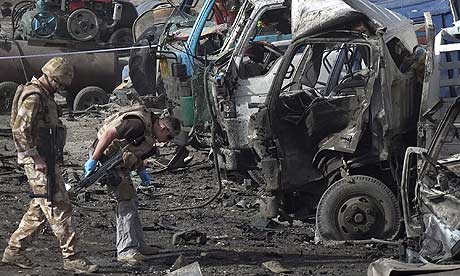 British soldiers survey the site of a bomb blast in Kabul