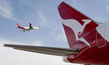 A Qantas 767 passenger jet flies over Sydney Airport 
