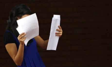 A girl looks at her A-level exam results 
