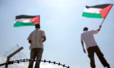 Protesters wave Palestinian flags during a protest in the West Bank.