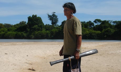 Melobo, shaman, standing on Xingu river
