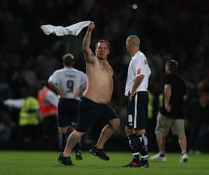 West Ham v Millwall: The Millwall players look less than impressed at the pitch invasion