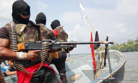 Separatist rebels brandish weapons on the Escravros River in the Niger Delta