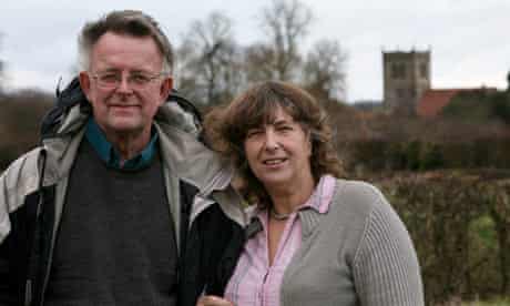 Andrew and Gail Wallbank with their local church in the background.