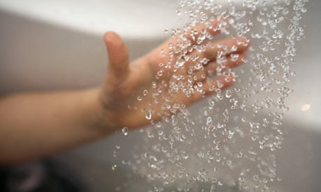 Shower blog: A hand reaching out to water from a shower