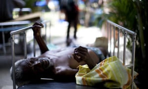 A man is treated in the yard of the general hospital in Port-au-Prince, Haiti.
