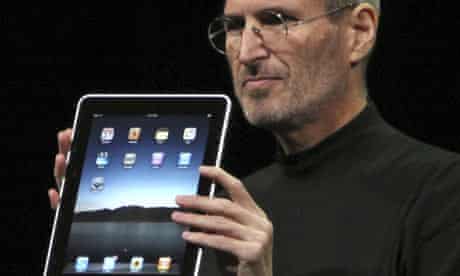 Apple CEO Steve Jobs holds the iPad