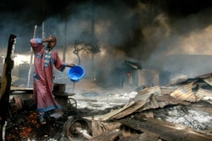 Pictures of the decade: A survivor rinses soot from his face after an oil pipeline explosion