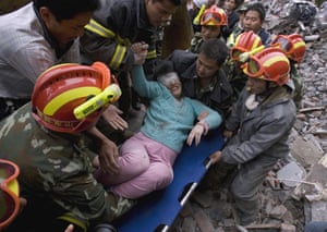 Pictures of the decade: A woman is rescued after a powerful earthquake in China